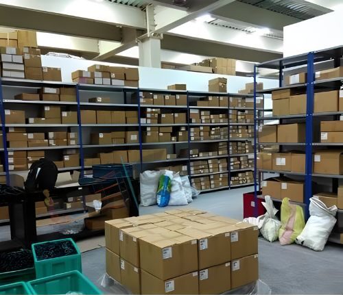 Slotted angle racks, Warehouse Racking System , slotted angle racks which are white and blue in color and consist of boxes all aroud the place on the shelves as well. Using slotted angle rack has come in handy to use the vertical height of the warehouse.