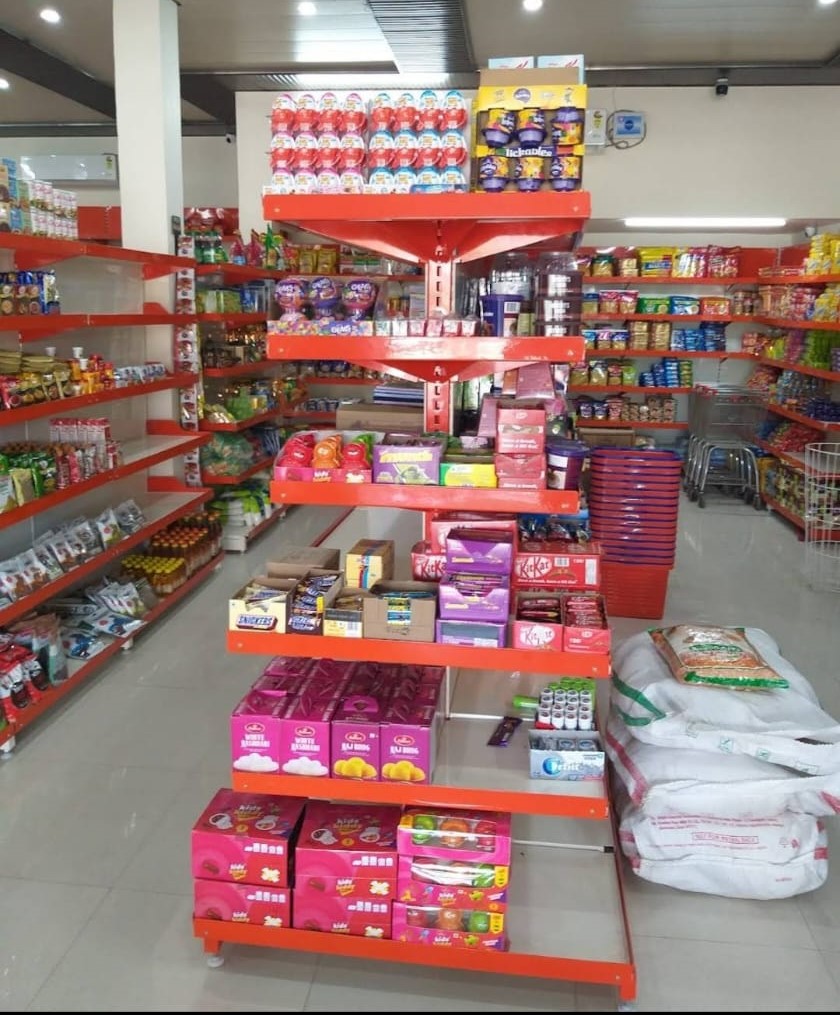 Cash Counter - For every Store, billing counter or cash counter is the underrated item. Mild Steel Racks, Display Racks in Meerut, Customized Racks for Shop, including a counter in orange and stainless steel and shop is filled with daily use items