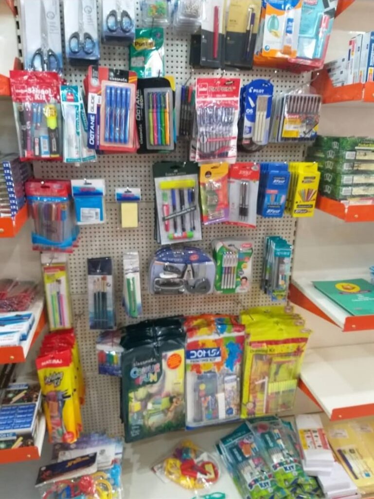 Perforated Racks - Used to hang small and light items for better visibility approach. Includes hooks of 6, 9, 12 inches. Mild Steel Racks, Display Racks in Meerut, Customized Racks for Shop, including a counter in orange and stainless steel and shop is filled with daily use items