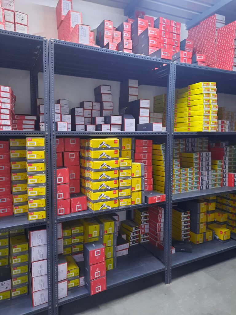 "GKSP Racking", Slotted angle rack Manufacturer in Bahadurgarh - Manufacturing slotted angle racks with GI panels from a decade. This rack has 7 feet height and is in dark grey color and have stored many types of boxes with electrical items/materials inside.