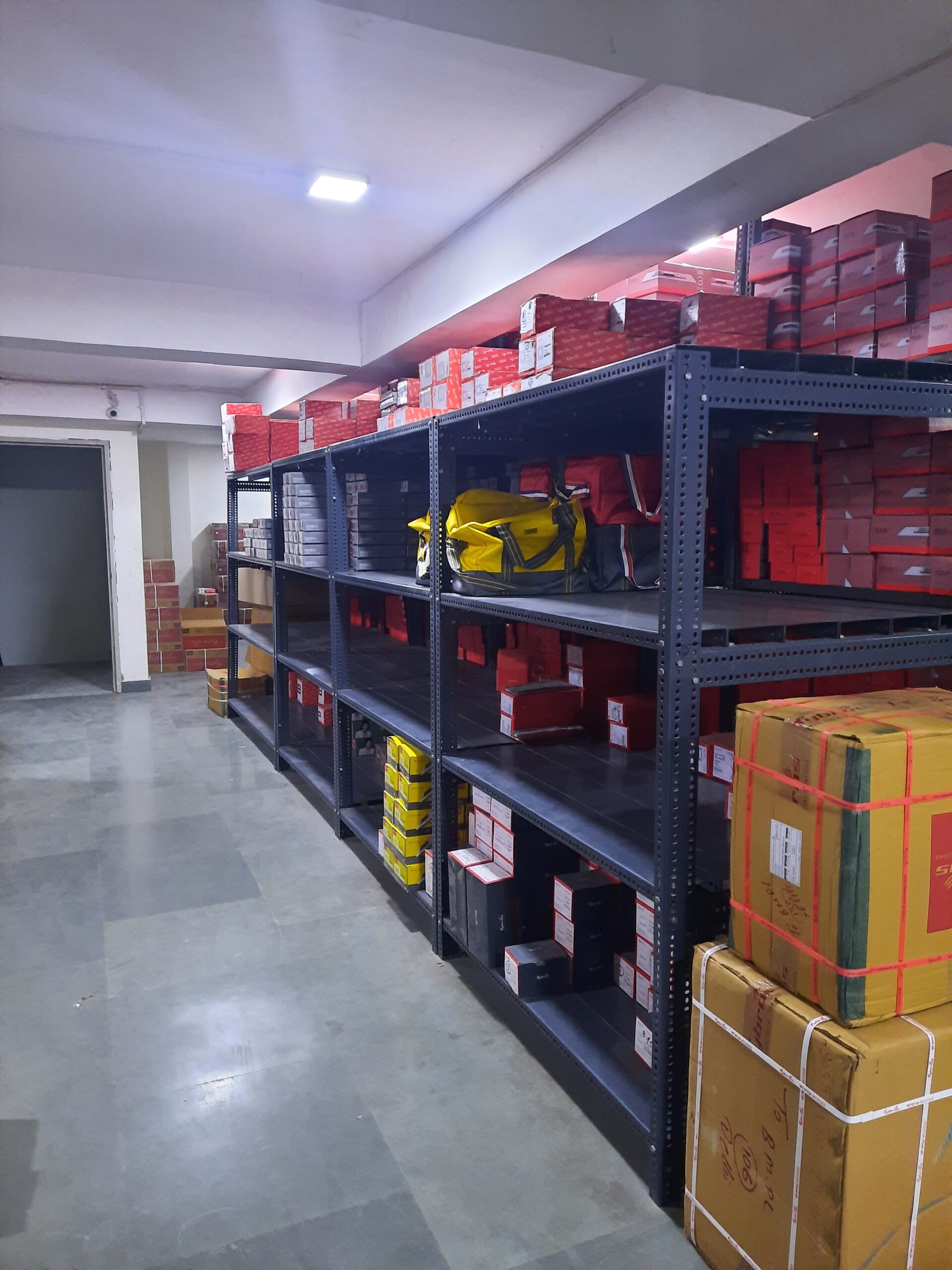 "GKSP Racking", Slotted angle rack Manufacturer in Bahadurgarh - Manufacturing slotted angle racks with GI panels from a decade. This rack has 7 feet height and is in dark grey color and have stored many types of boxes with electrical items/materials inside.